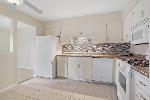 kitchen with backsplash, white cabinets, and white appliances