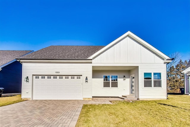 view of front of property with a front yard and a garage