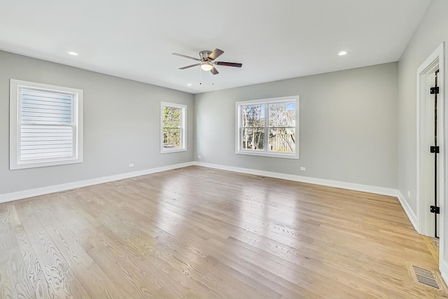 spare room featuring light wood-type flooring and ceiling fan