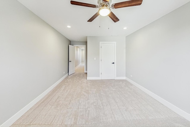 unfurnished bedroom featuring ceiling fan and light colored carpet