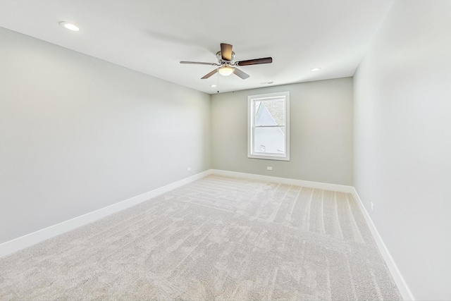 carpeted spare room with ceiling fan