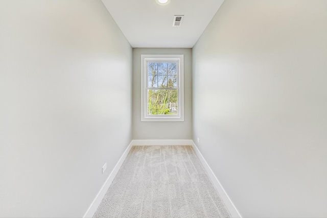 spare room featuring light colored carpet