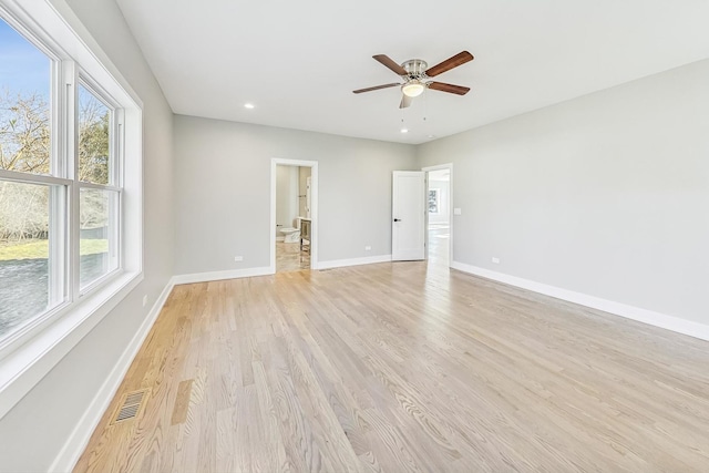 unfurnished room featuring ceiling fan, light hardwood / wood-style floors, and a healthy amount of sunlight