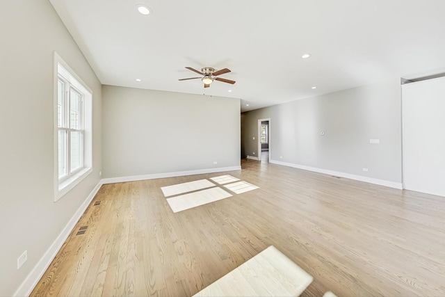 unfurnished room featuring light wood-type flooring and ceiling fan