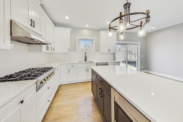 kitchen with decorative light fixtures, stainless steel gas cooktop, and white cabinetry