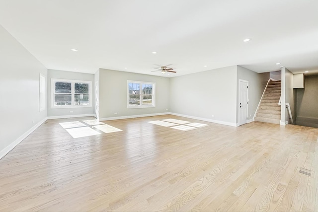 unfurnished living room with ceiling fan and light hardwood / wood-style flooring