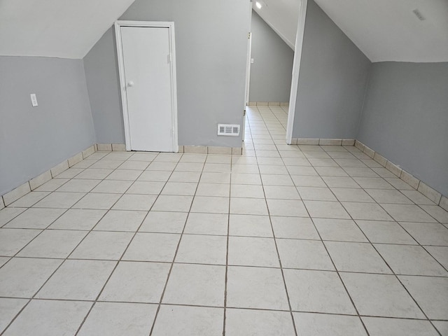 bonus room featuring vaulted ceiling and light tile patterned flooring