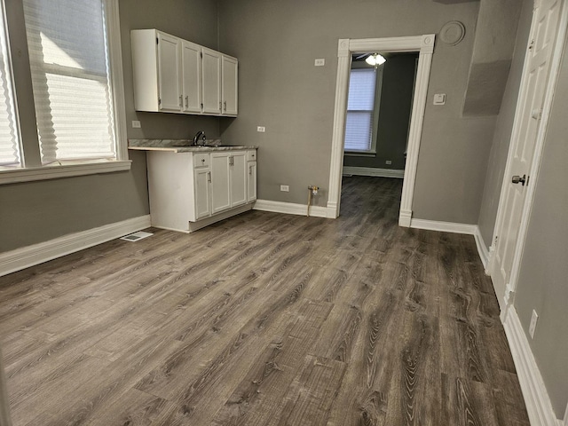 laundry room with sink and dark wood-type flooring