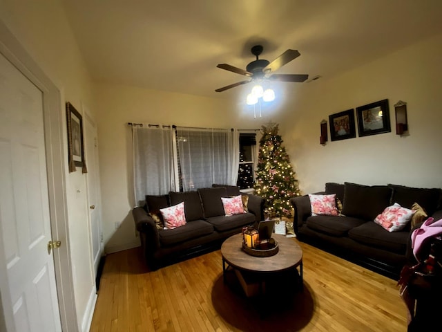 living room featuring hardwood / wood-style flooring and ceiling fan