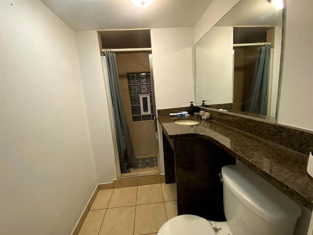 bathroom featuring tile patterned flooring, vanity, a shower with shower curtain, and toilet