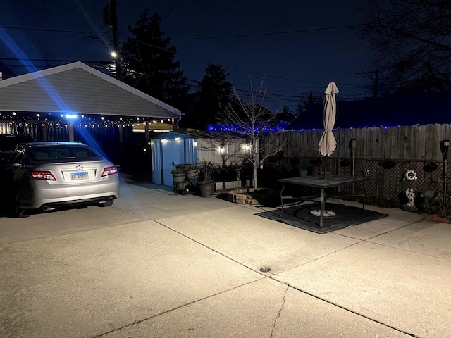 patio at twilight featuring a storage shed