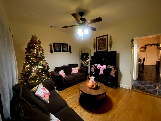 living room featuring ceiling fan and light hardwood / wood-style floors