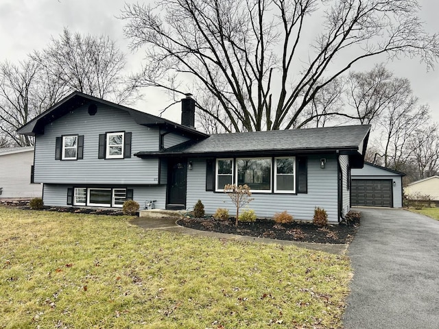 split level home with a front yard and a garage