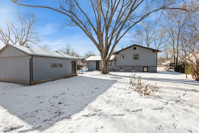 view of snow covered rear of property