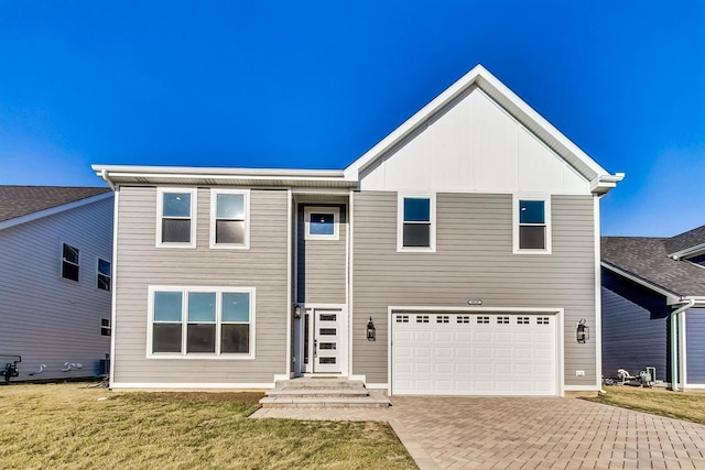 view of front of house featuring a front yard and a garage