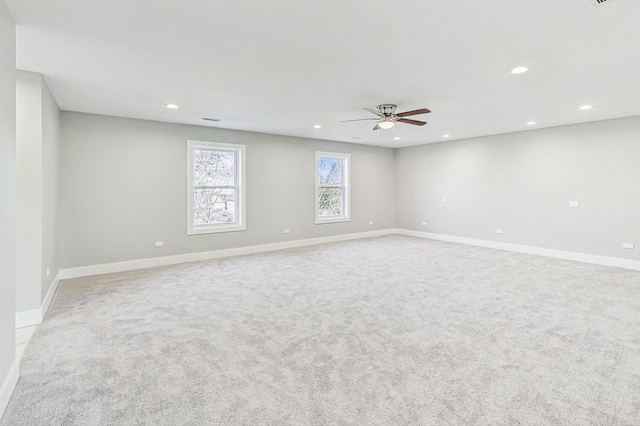 carpeted spare room with ceiling fan