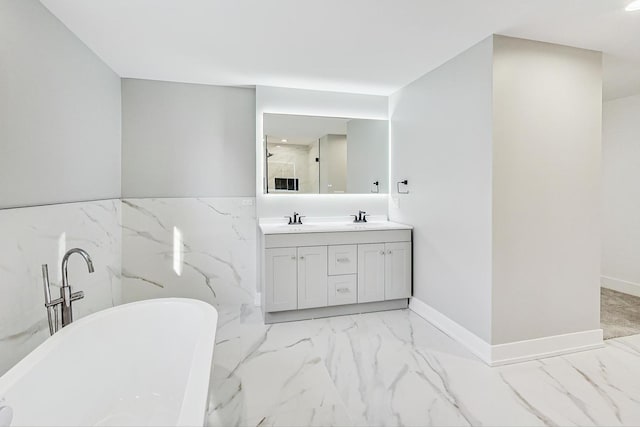 bathroom featuring vanity, tile walls, and a tub