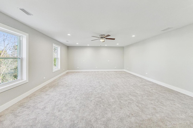 empty room with ceiling fan and carpet floors