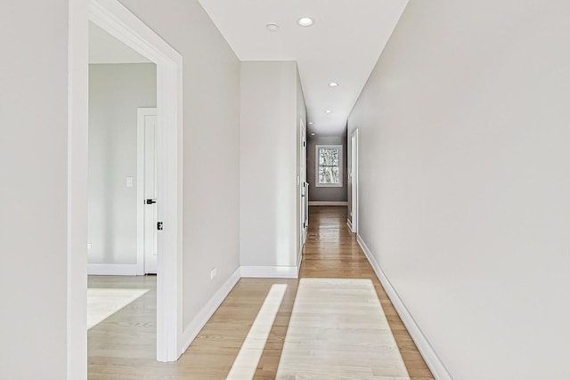 corridor with light hardwood / wood-style floors