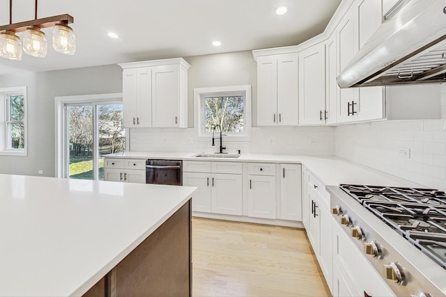 kitchen with ventilation hood, sink, hanging light fixtures, white cabinetry, and stainless steel gas cooktop