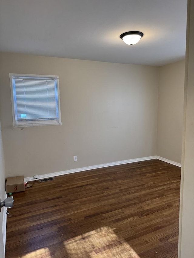 unfurnished room featuring dark wood-type flooring