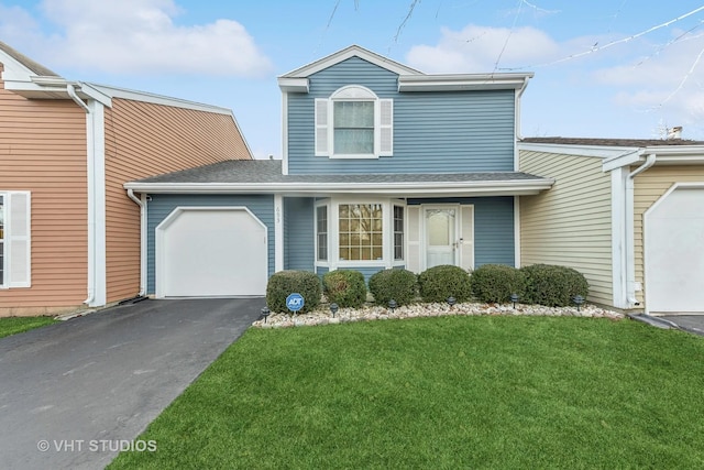 view of property with a front yard and a garage