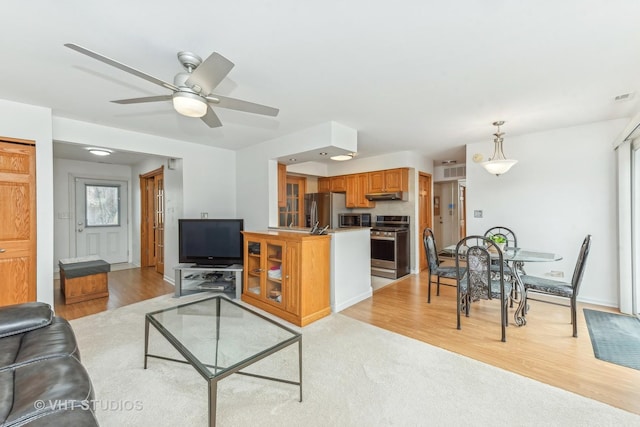 living room with ceiling fan and light hardwood / wood-style floors