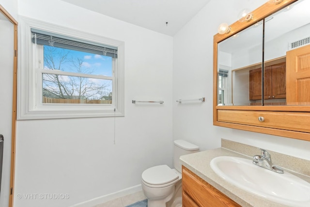 bathroom with tile patterned flooring, vanity, and toilet