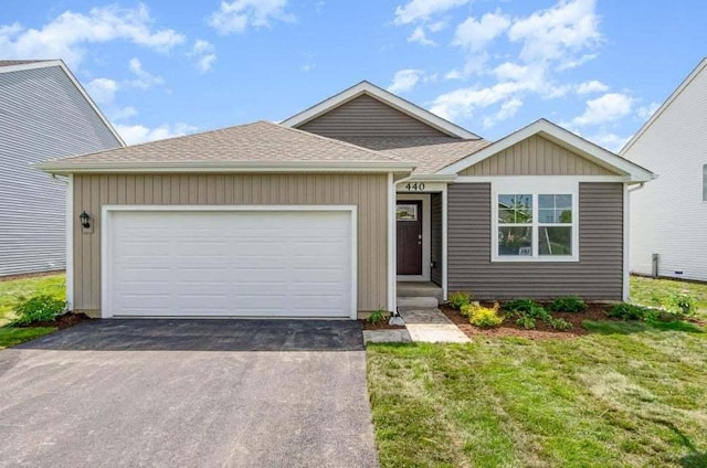 view of front of home with a garage and a front lawn