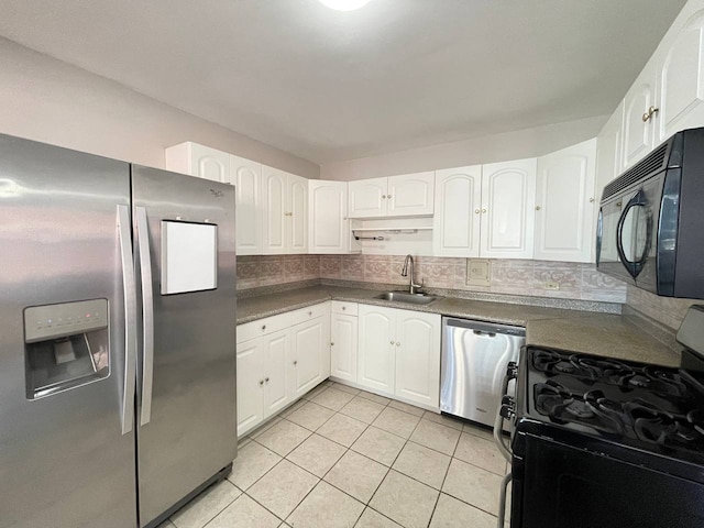 kitchen featuring black appliances, light tile patterned flooring, white cabinetry, and sink