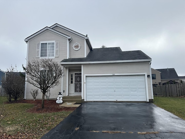 front facade featuring a front lawn and a garage