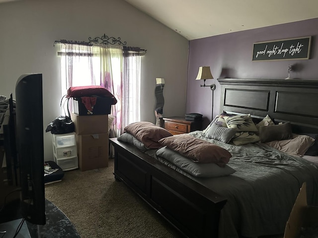 carpeted bedroom with lofted ceiling