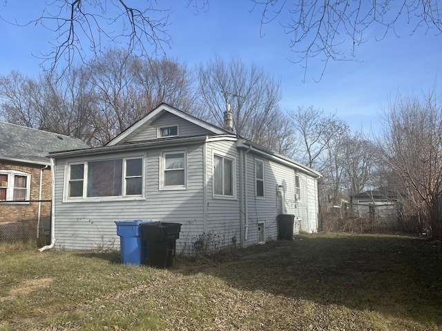 view of side of home featuring a lawn