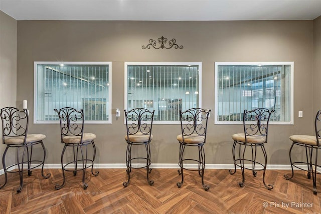 dining space featuring parquet flooring