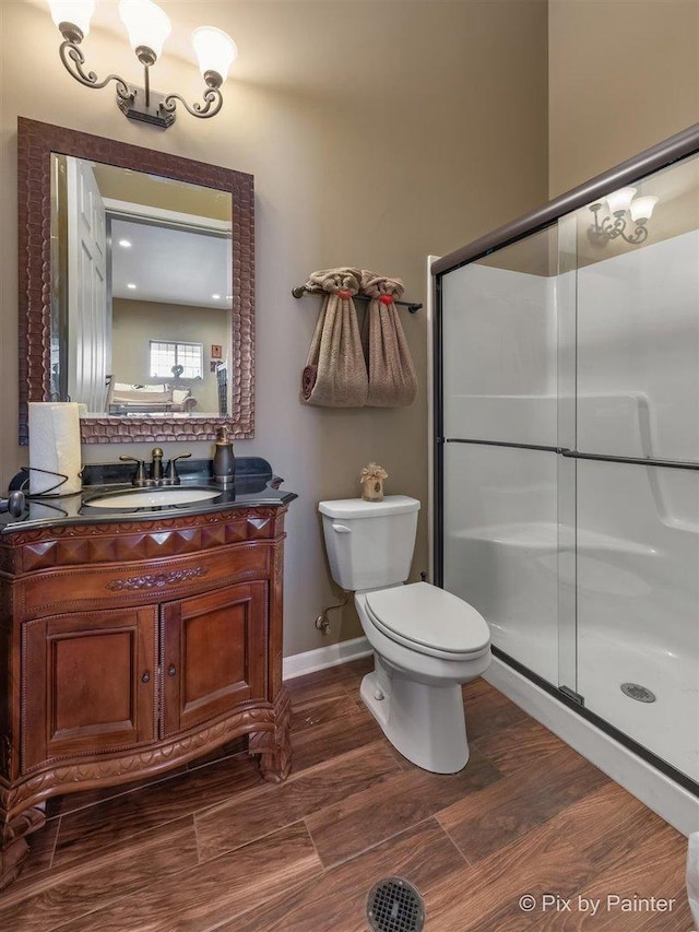 bathroom featuring vanity, toilet, and an enclosed shower