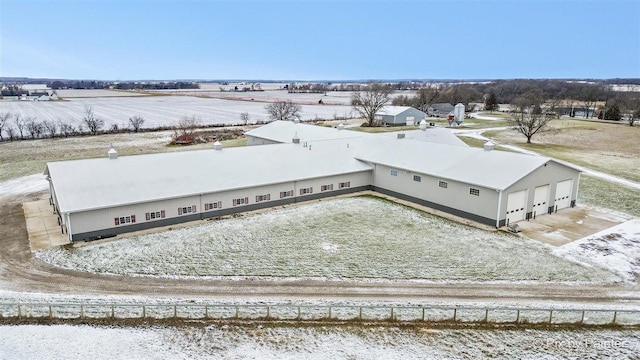 snowy aerial view featuring a rural view