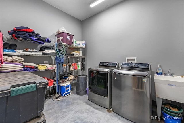 laundry area with washer and clothes dryer and sink