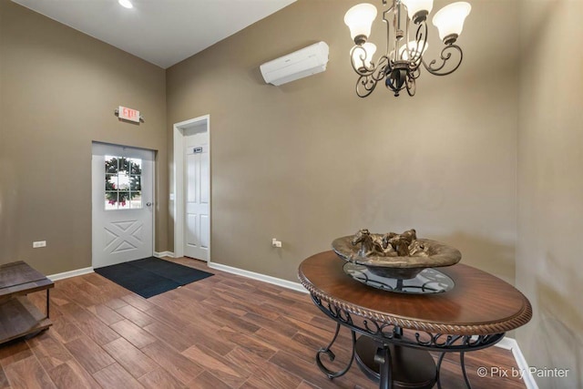 entrance foyer with a wall mounted AC and a notable chandelier