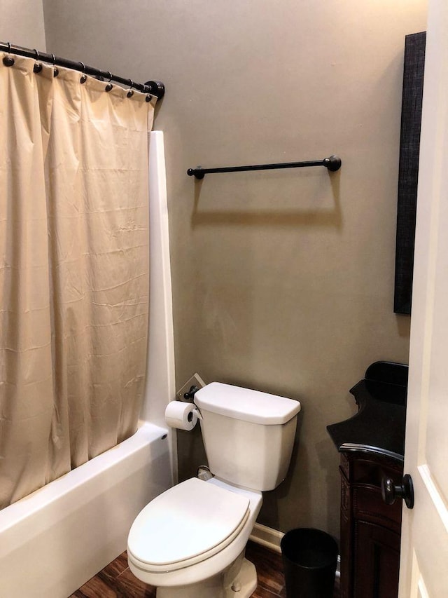 bathroom featuring toilet, shower / tub combo, and hardwood / wood-style flooring