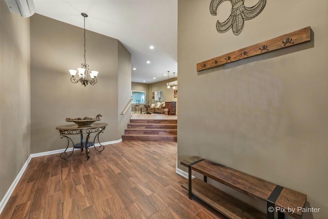 hall with hardwood / wood-style flooring and an inviting chandelier