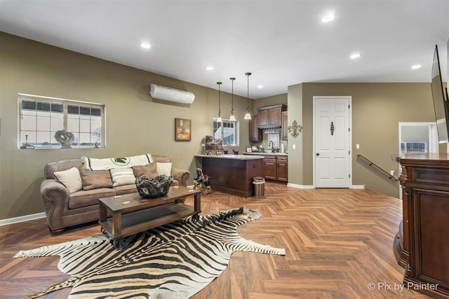 living room with a wall mounted air conditioner, light parquet flooring, and sink