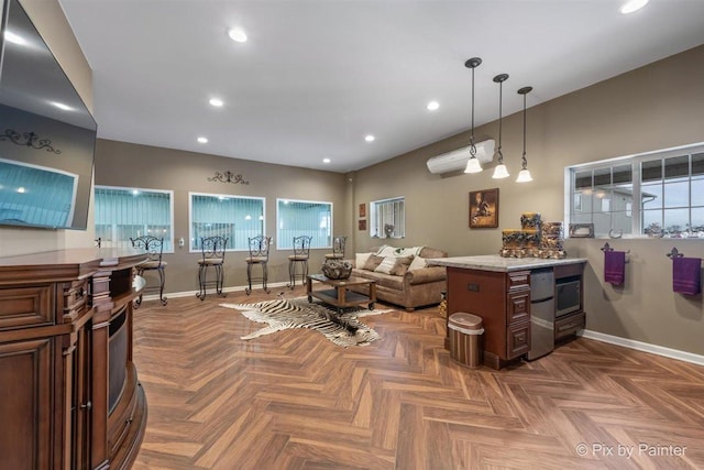 interior space with refrigerator, hanging light fixtures, parquet floors, and a wall mounted AC