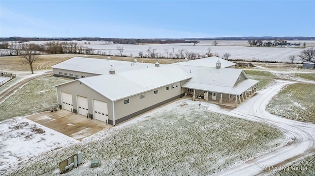 snowy aerial view featuring a rural view