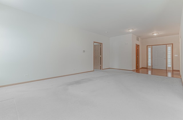 empty room featuring light colored carpet