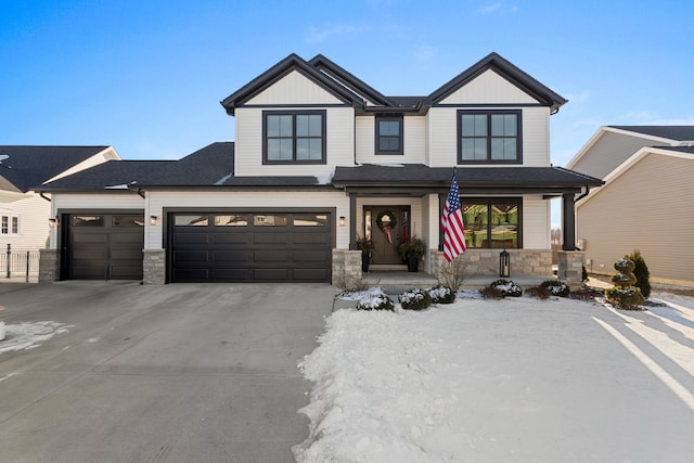 craftsman inspired home featuring a garage and a porch