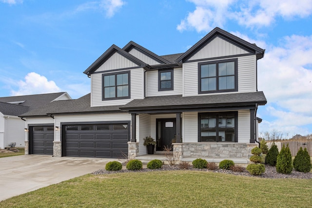 507 Wheatley Dr, Mahomet, IL 61853 - view of front of house with stone siding, driveway, a front lawn, and board and batten siding