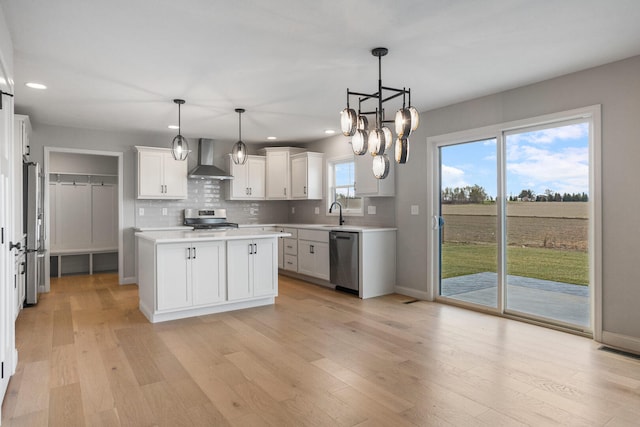 507 Wheatley Dr, Mahomet, IL 61853 - kitchen with light wood finished floors, wall chimney exhaust hood, appliances with stainless steel finishes, visible vents, and decorative backsplash