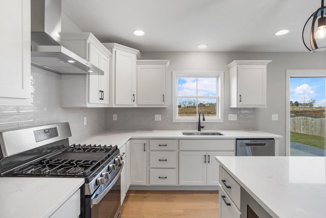 507 Wheatley Dr, Mahomet, IL 61853 - kitchen featuring wall chimney exhaust hood, a sink, stainless steel appliances, and plenty of natural light