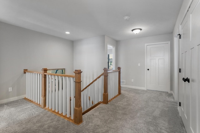 hallway featuring light carpet