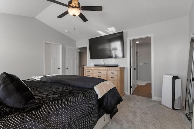 carpeted bedroom with lofted ceiling, ensuite bath, and ceiling fan